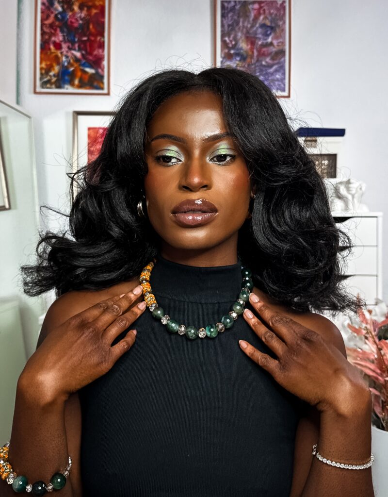 Self portrait with green sparkle eye make up wearing green accessories.