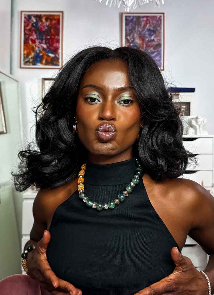 Self portrait with green sparkle eye make up wearing green accessories.