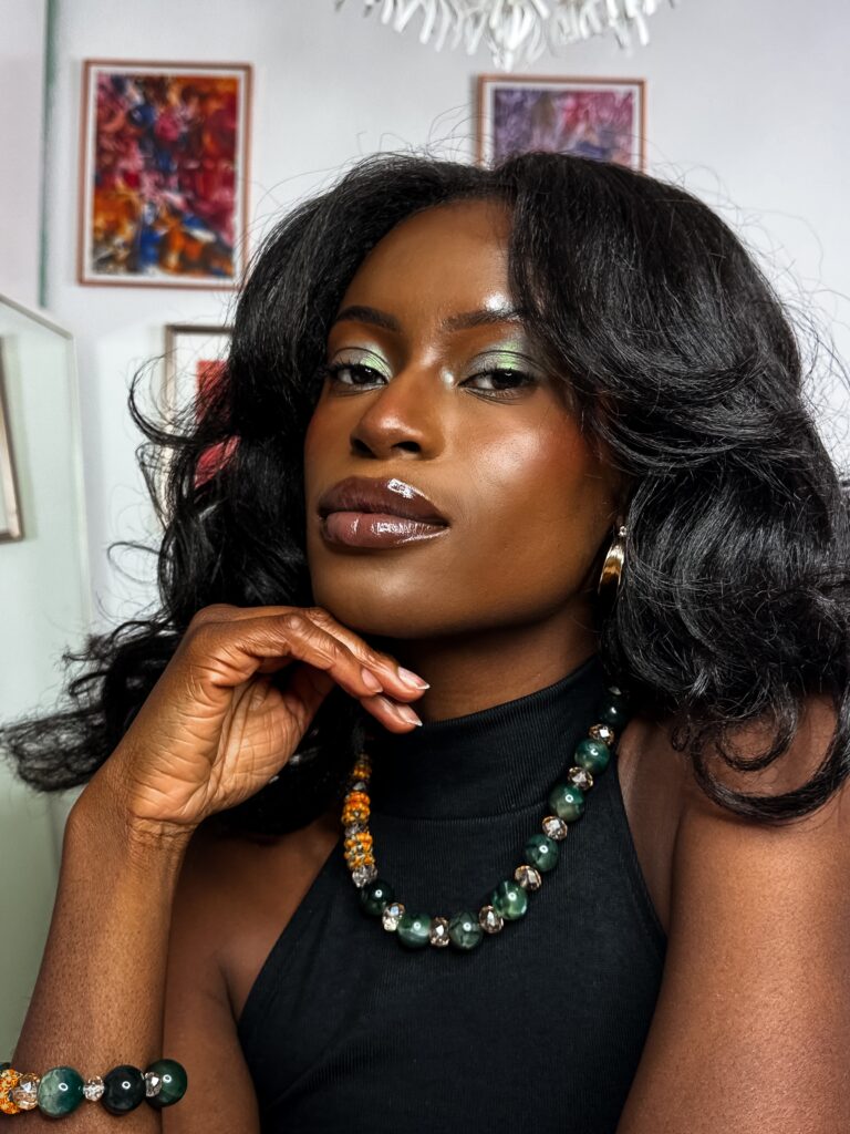 Self portrait with green sparkle eye make up wearing green accessories.