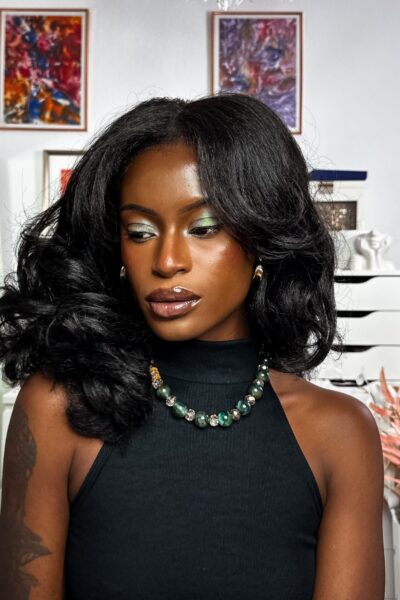 Self portrait with green sparkle eye make up wearing green accessories.