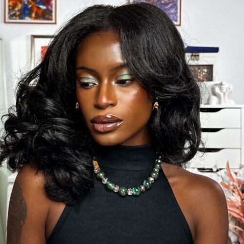 Self portrait with green sparkle eye make up wearing green accessories.