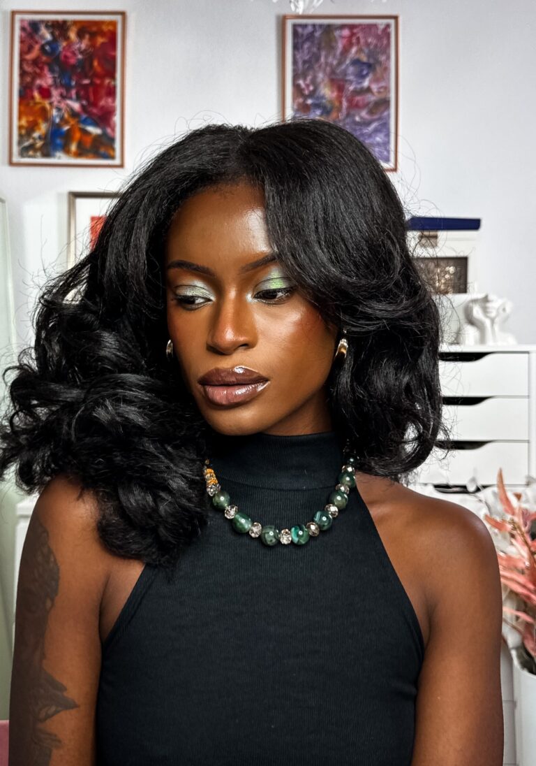 Self portrait with green sparkle eye make up wearing green accessories.